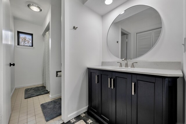full bath featuring baseboards, tile patterned floors, and vanity