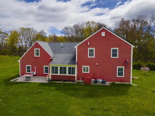 267 Chase Rd, Thompson, CT 06277 - back of property with a patio area, a lawn, cooling unit, and a shingled roof