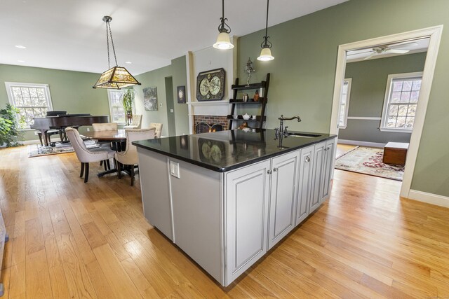 267 Chase Rd, Thompson, CT 06277 - kitchen with dark countertops, light wood finished floors, a sink, and pendant lighting