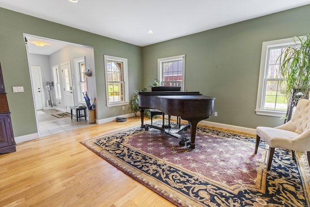 living area featuring baseboards, recessed lighting, and wood finished floors