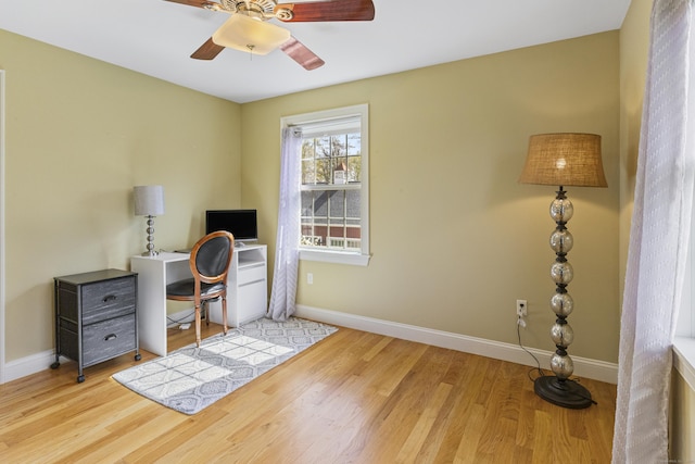 office area featuring baseboards, a ceiling fan, and wood finished floors