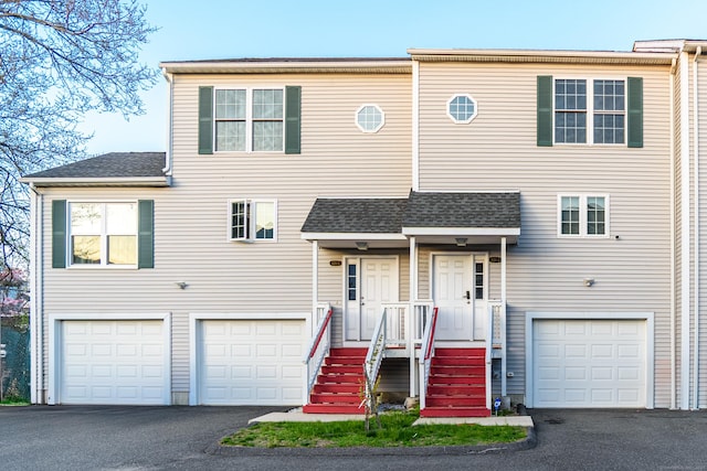 view of front of property with an attached garage and aphalt driveway
