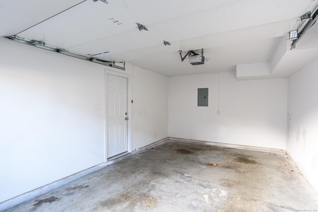 garage with a garage door opener and electric panel
