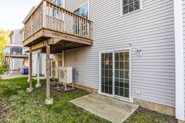 back of property featuring ac unit, a yard, and a deck