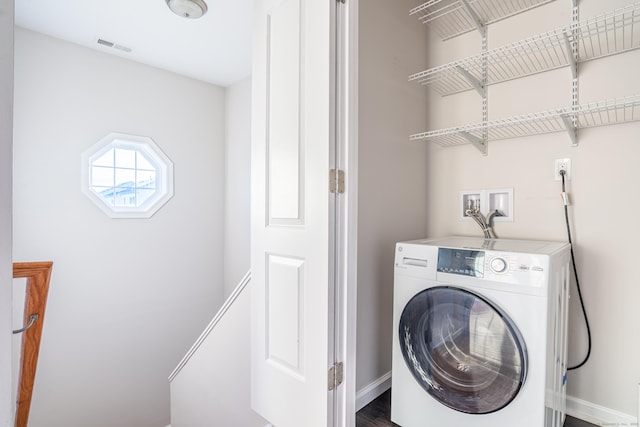 washroom with washer / clothes dryer, laundry area, visible vents, and baseboards