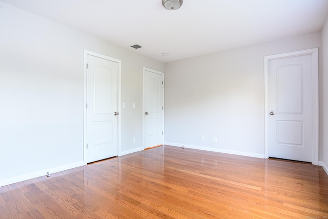 unfurnished bedroom featuring baseboards and light wood-style floors
