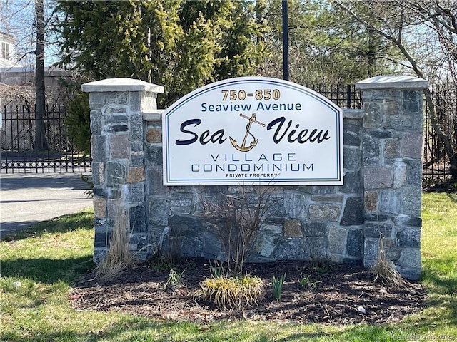 community / neighborhood sign with fence