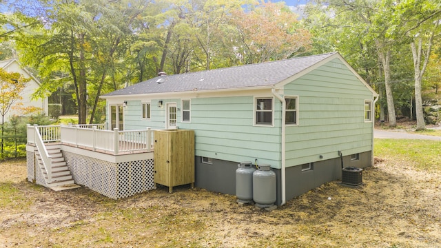 rear view of house with central AC unit, a deck, and stairway