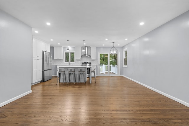 interior space with recessed lighting, baseboards, and dark wood-style floors