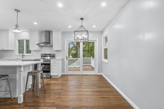 kitchen featuring electric range, dark wood finished floors, wall chimney exhaust hood, white cabinetry, and decorative backsplash