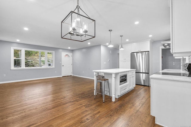 kitchen with stainless steel appliances, recessed lighting, white cabinetry, and dark wood finished floors