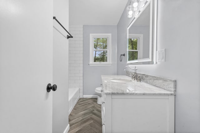 full bath with toilet, baseboards, shower / bathing tub combination, and vanity