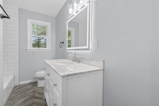 bathroom featuring vanity, baseboards, and toilet