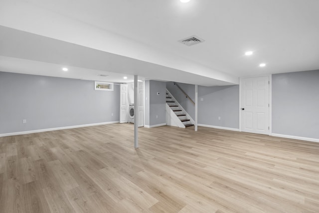 basement featuring visible vents, recessed lighting, washer / dryer, and light wood-style flooring