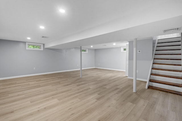 below grade area featuring visible vents, stairs, baseboards, light wood-style floors, and recessed lighting