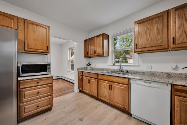 291 E St, New Britain, CT 06051 - kitchen with a healthy amount of sunlight, stainless steel appliances, light wood-type flooring, and a sink