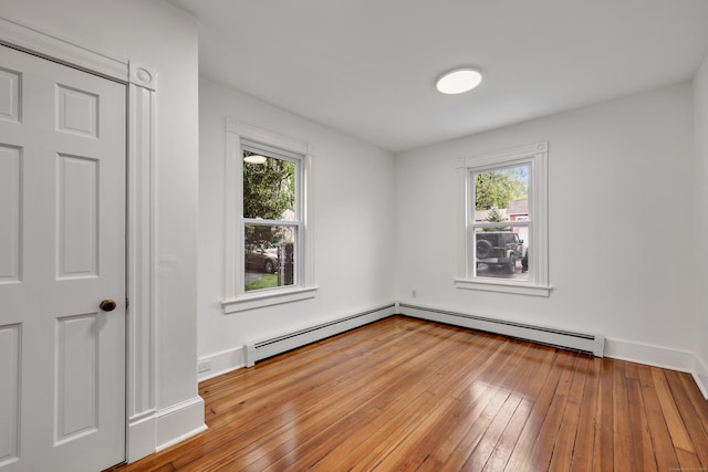 291 E St, New Britain, CT 06051 - unfurnished room with a baseboard radiator, hardwood / wood-style flooring, and baseboards