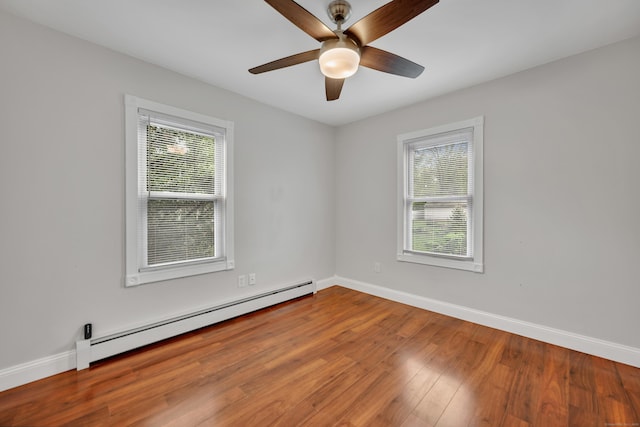 291 E St, New Britain, CT 06051 - empty room featuring a healthy amount of sunlight, baseboards, baseboard heating, and wood finished floors
