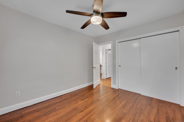 291 E St, New Britain, CT 06051 - unfurnished bedroom featuring a closet, a ceiling fan, wood finished floors, and baseboards