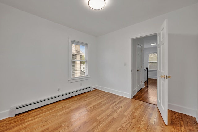 291 E St, New Britain, CT 06051 - spare room with light wood-type flooring, baseboards, and baseboard heating