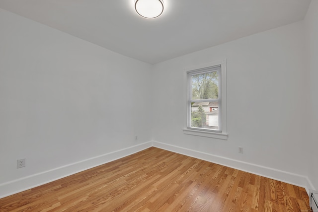 291 E St, New Britain, CT 06051 - spare room featuring a baseboard radiator, baseboards, and light wood-style floors