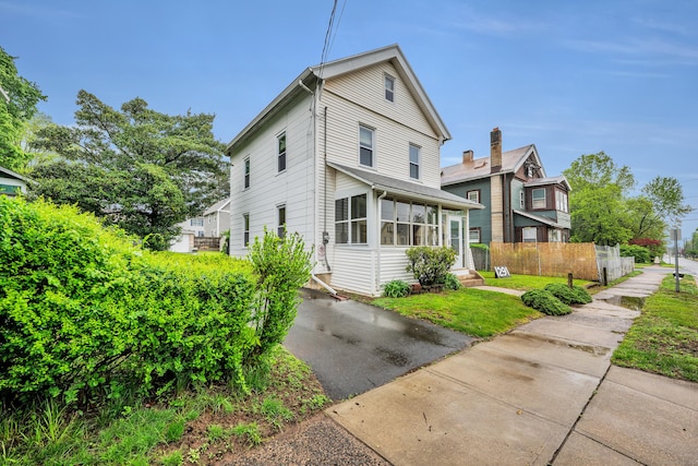 291 E St, New Britain, CT 06051 - view of side of property featuring a sunroom and fence