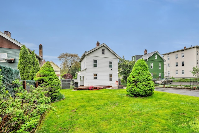 291 E St, New Britain, CT 06051 - back of house featuring a lawn, a deck, a chimney, and fence