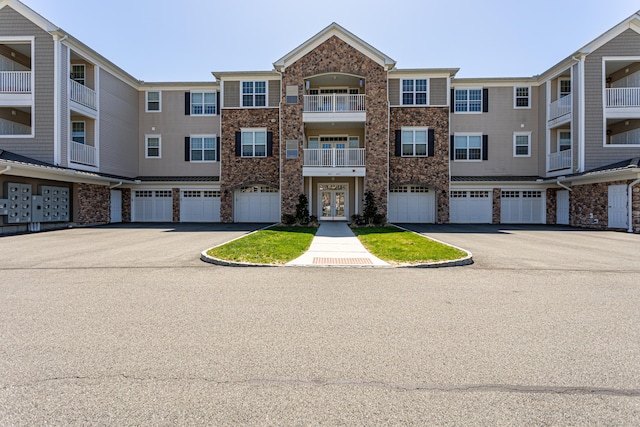 411 Brookside Ct Unit 411, Newtown, CT 06470 - townhome / multi-family property with an attached garage, driveway, and stone siding