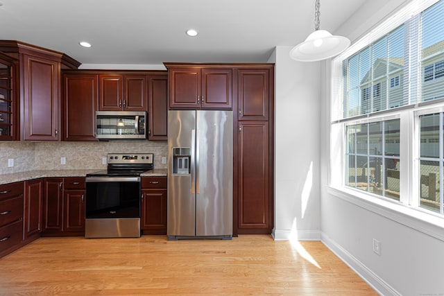 411 Brookside Ct Unit 411, Newtown, CT 06470 - kitchen featuring stainless steel appliances, light wood-type flooring, decorative backsplash, light stone countertops, and baseboards