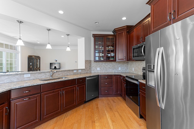 411 Brookside Ct Unit 411, Newtown, CT 06470 - kitchen featuring appliances with stainless steel finishes, a sink, light wood-style floors, decorative light fixtures, and glass insert cabinets