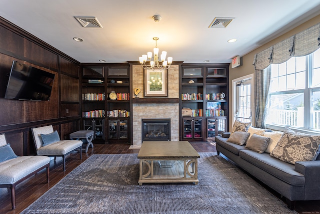 411 Brookside Ct Unit 411, Newtown, CT 06470 - living area with a chandelier, dark wood-type flooring, a large fireplace, built in shelves, and recessed lighting
