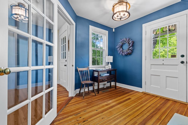 34 W Ave, Essex, CT 06426 - entryway with wood-type flooring and a chandelier