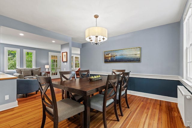34 W Ave, Essex, CT 06426 - dining area with radiator heating unit, light wood finished floors, a chandelier, and recessed lighting