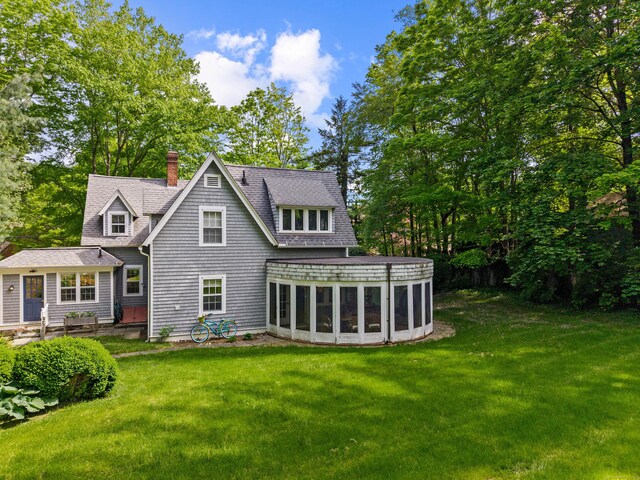 34 W Ave, Essex, CT 06426 - rear view of property with a sunroom, a lawn, a chimney, and roof with shingles