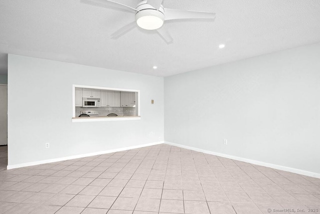 unfurnished room with a textured ceiling, baseboards, a ceiling fan, and recessed lighting