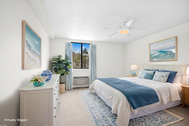 bedroom with light colored carpet and a ceiling fan