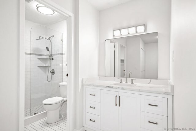 full bath with vanity, toilet, and a stall shower