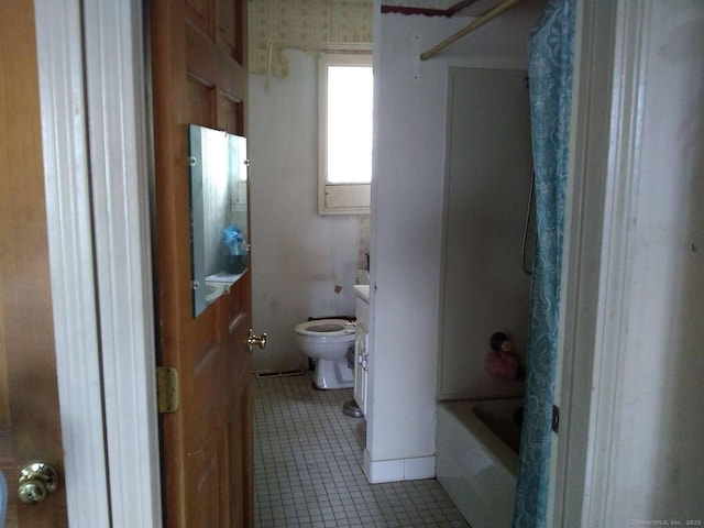 bathroom featuring tile patterned flooring, bathtub / shower combination, toilet, and vanity