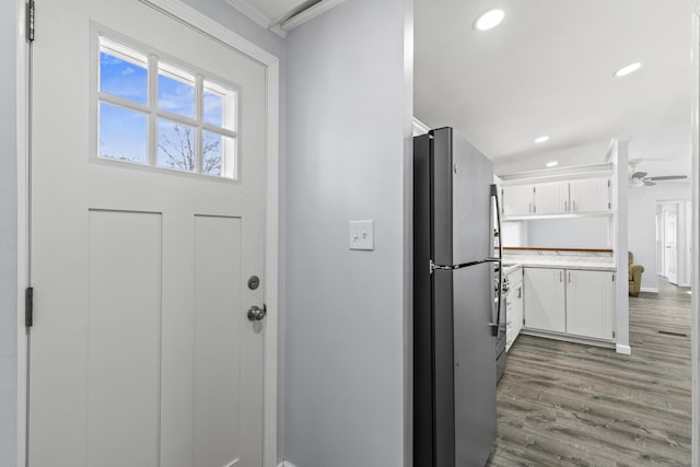 doorway to outside with recessed lighting, ornamental molding, baseboards, and wood finished floors