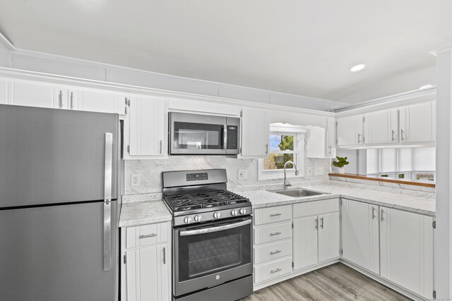 kitchen featuring white cabinetry, appliances with stainless steel finishes, and a sink