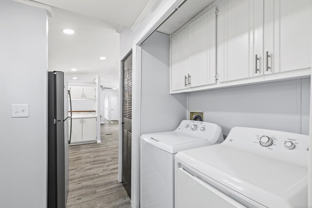 washroom with recessed lighting, laundry area, washing machine and dryer, and light wood-type flooring