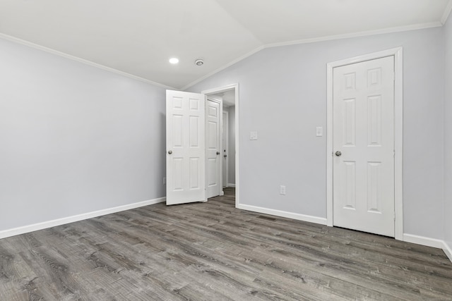 unfurnished bedroom with baseboards, ornamental molding, and wood finished floors