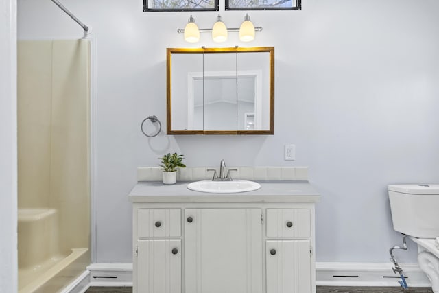full bathroom with vanity, baseboards, and a shower with shower curtain