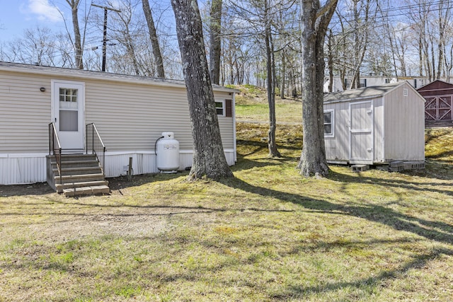 view of yard featuring entry steps, an outbuilding, and a shed