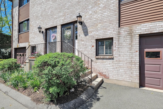 44 Columbus Pl Unit 2, Stamford, CT 06907 - property entrance featuring a garage and brick siding