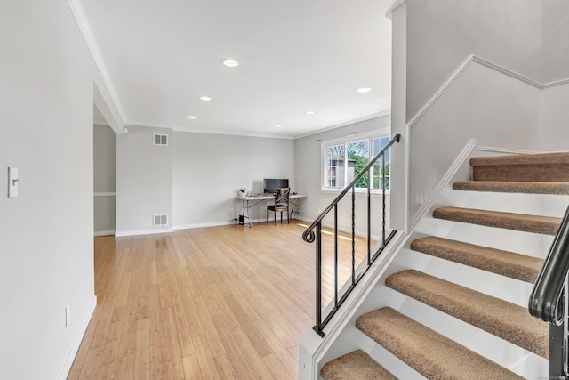 44 Columbus Pl Unit 2, Stamford, CT 06907 - staircase featuring wood finished floors, crown molding, baseboards, and recessed lighting
