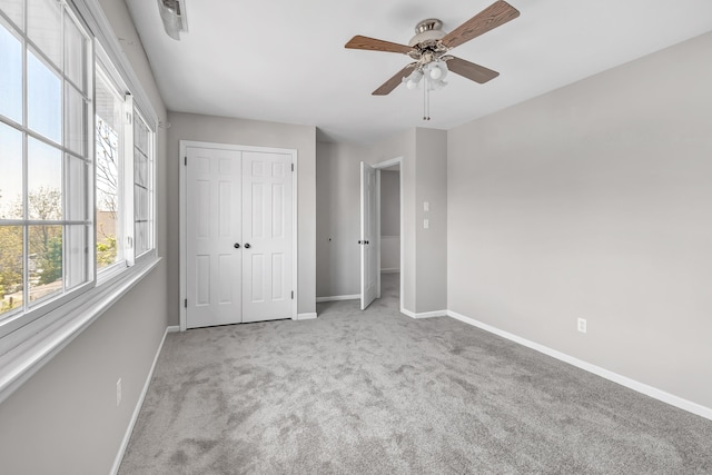 44 Columbus Pl Unit 2, Stamford, CT 06907 - unfurnished bedroom with baseboards, carpet flooring, a closet, and a ceiling fan