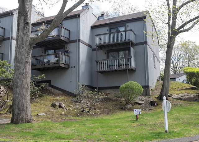 34 Harbour Vlg Unit A, Branford, CT 06405 - back of house featuring a lawn and a chimney