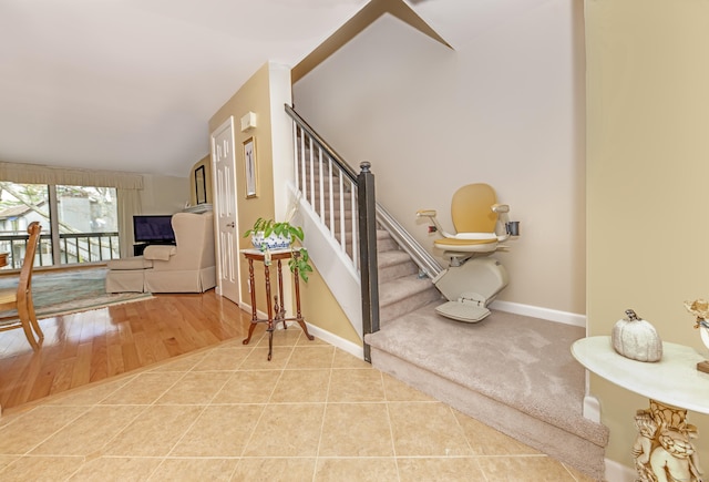 stairway featuring baseboards and tile patterned floors
