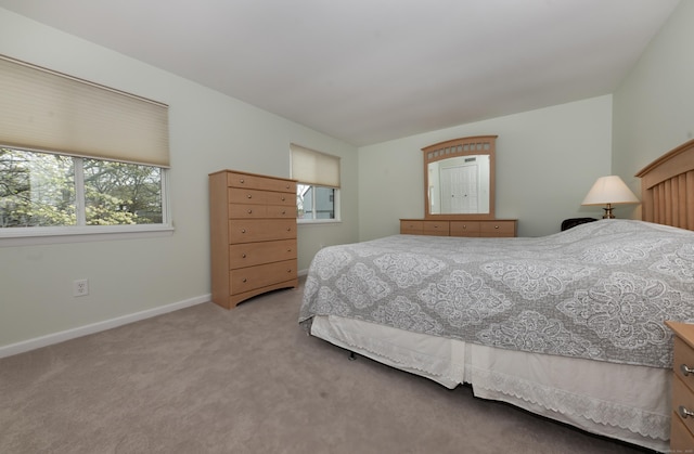 bedroom featuring carpet floors and baseboards